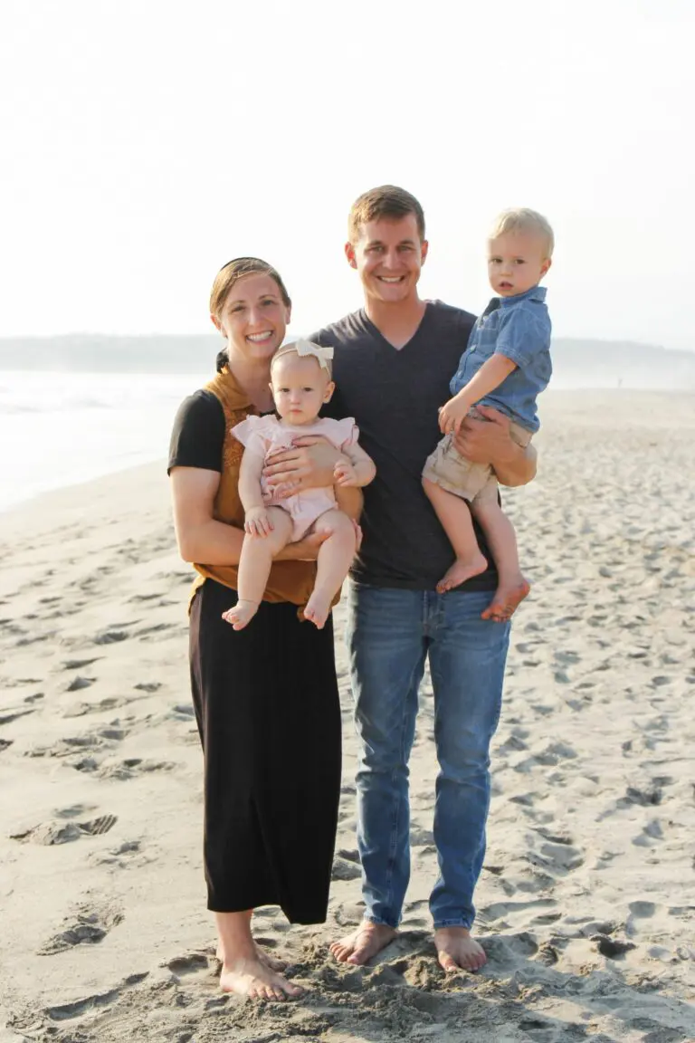 A family posing for a photo on the beach showcases a Light of Hope Orphanage Website Redesign.